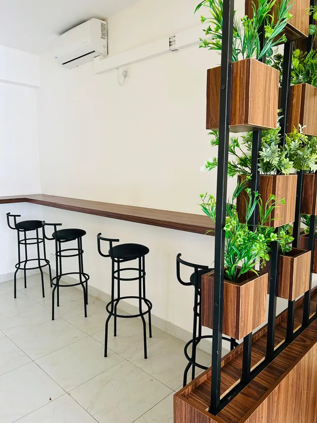 High stools and counter seating beside planter partitions in the ILT student area