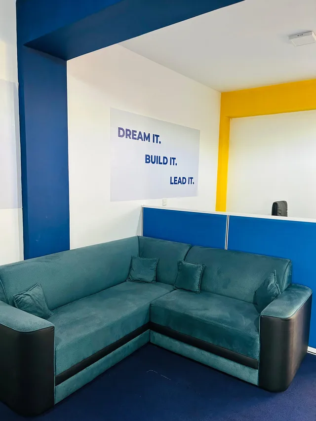 Sofa seating beside blue and yellow walls at ILT